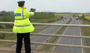 Mobile speed camera by the roadside, viewed from a driver's perspective